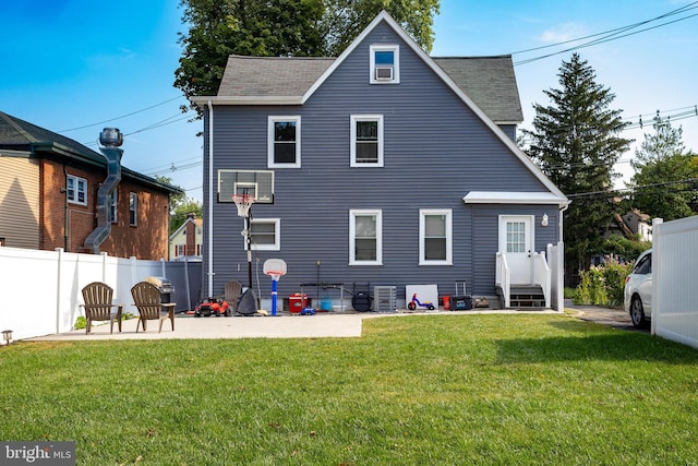 back of property featuring a yard