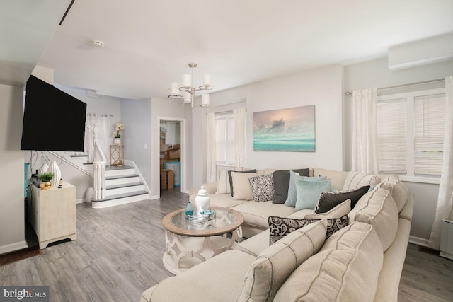 living room with a notable chandelier and light wood-type flooring