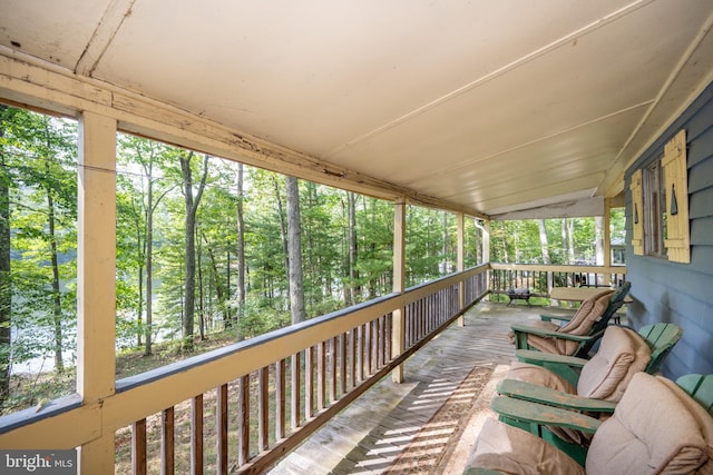 sunroom with lofted ceiling and a wealth of natural light