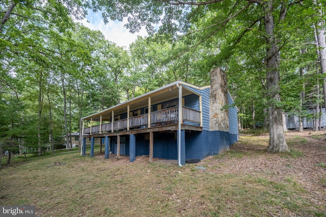 back of house with a lawn