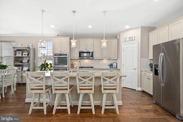 kitchen featuring hanging light fixtures, stainless steel appliances, and dark wood-type flooring