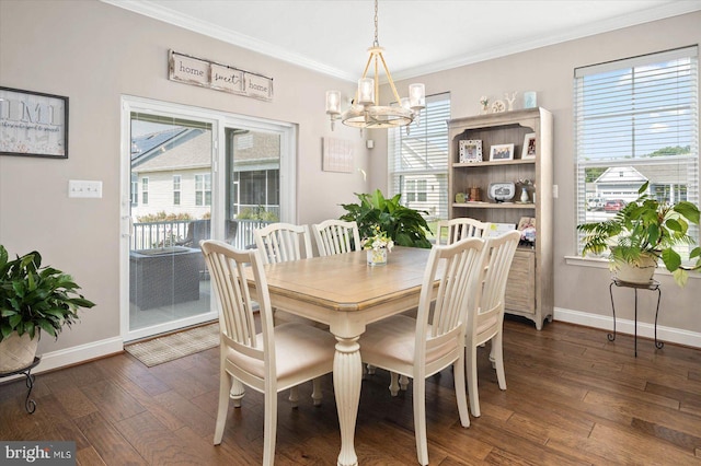 dining space featuring an inviting chandelier, crown molding, dark hardwood / wood-style floors, and a wealth of natural light