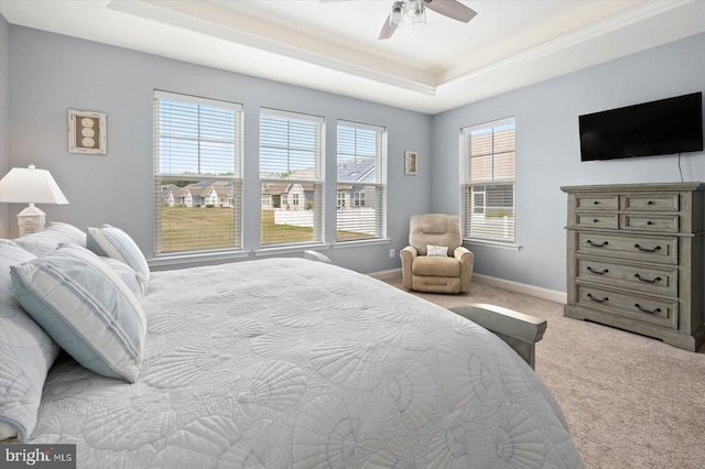 bedroom featuring a tray ceiling, ceiling fan, and light colored carpet