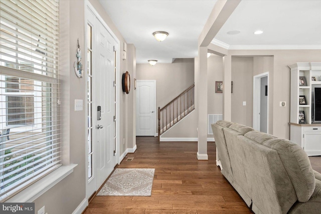 foyer featuring ornamental molding and wood-type flooring