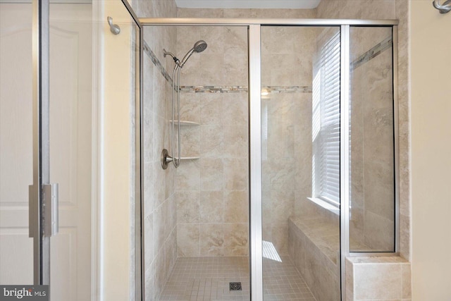 bathroom with a shower with door