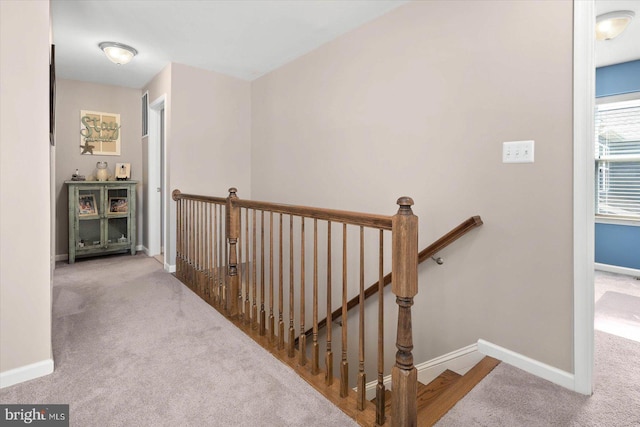 hall featuring light colored carpet