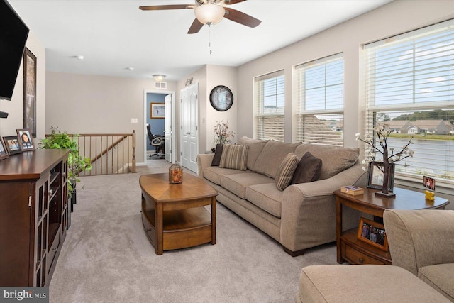 living room with ceiling fan and light colored carpet