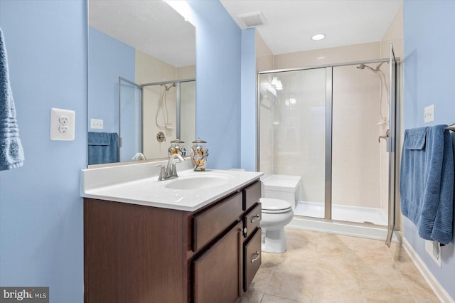 bathroom with toilet, tile floors, a shower with shower door, and vanity