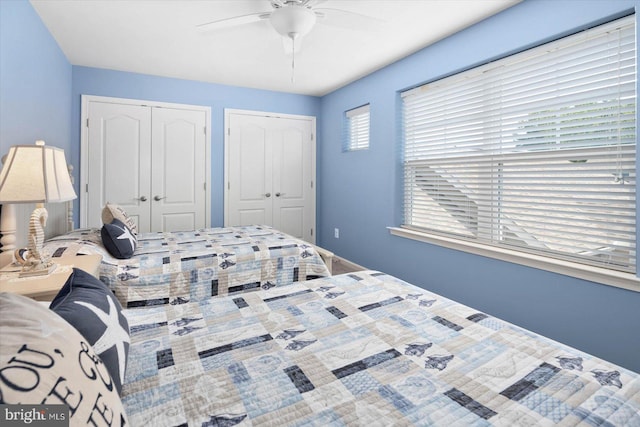 bedroom with two closets and ceiling fan