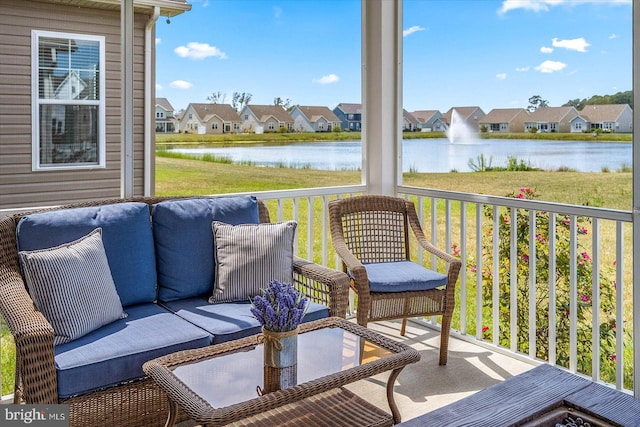 wooden deck with a water view and a yard