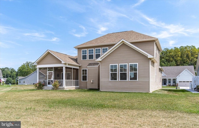 view of front of property featuring a sunroom, a front lawn, and a garage