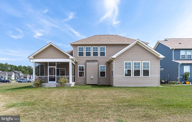 rear view of property with a lawn