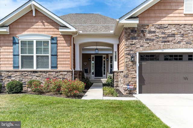 entrance to property with a lawn and a garage