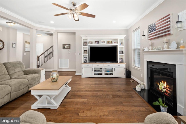 living room featuring ceiling fan, dark wood-type flooring, and ornamental molding