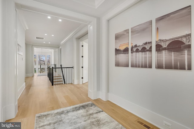 hallway with crown molding and hardwood / wood-style floors