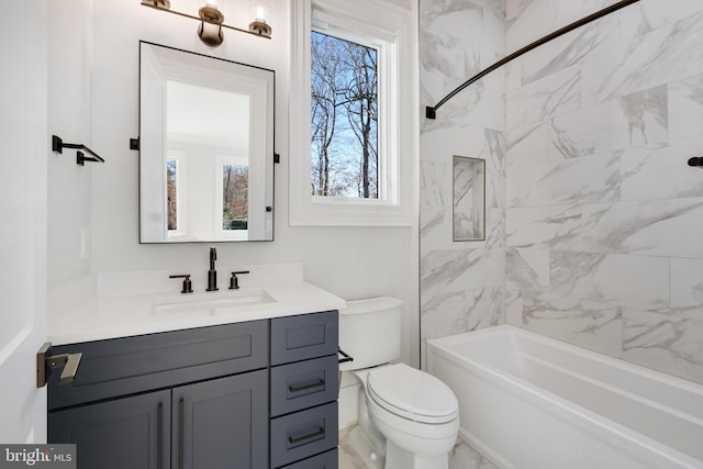 full bathroom with vanity, toilet, and tiled shower / bath