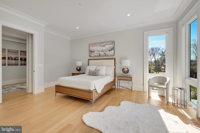 bedroom featuring light hardwood / wood-style floors and ornamental molding