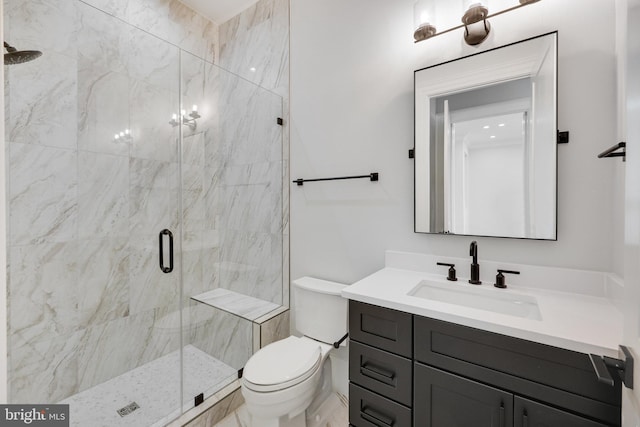 bathroom featuring vanity, toilet, and an enclosed shower