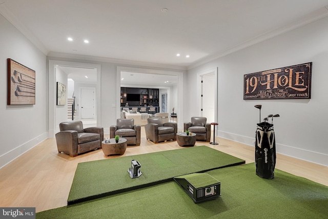 living room featuring hardwood / wood-style flooring, golf simulator, and crown molding