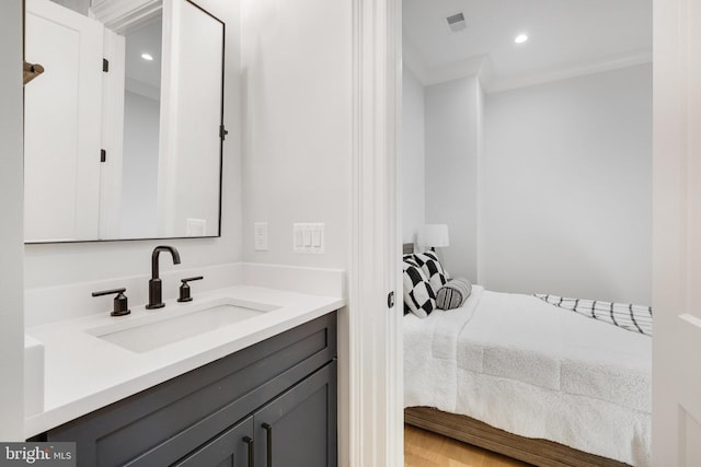 bathroom featuring crown molding and vanity