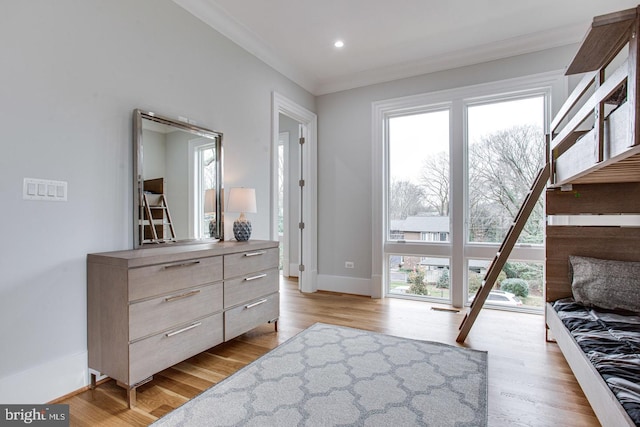 bedroom featuring crown molding and light hardwood / wood-style floors