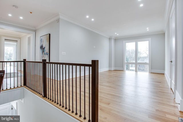 unfurnished room with light wood-type flooring and crown molding