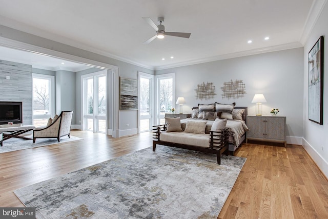 bedroom featuring ceiling fan, light hardwood / wood-style floors, and ornamental molding