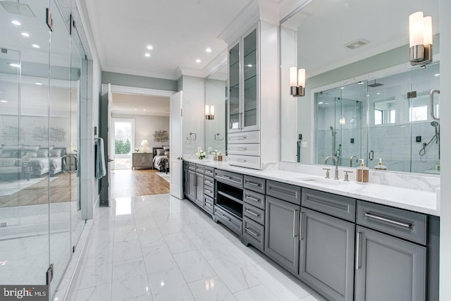 bathroom featuring vanity, ornamental molding, and a shower with door