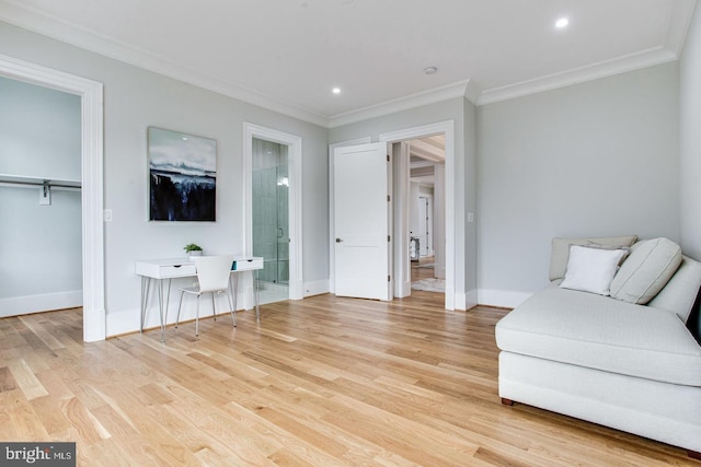 living area with crown molding and light wood-type flooring