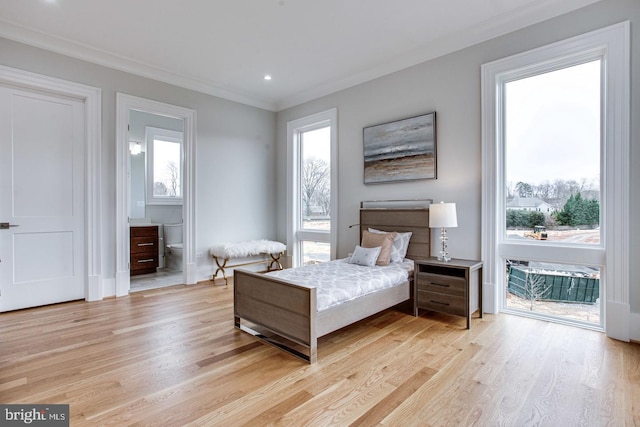 bedroom featuring access to outside, light hardwood / wood-style floors, ornamental molding, and ensuite bathroom