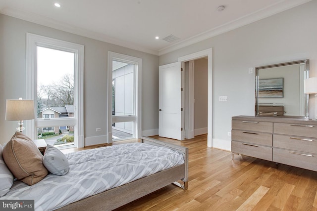 bedroom with light hardwood / wood-style floors and crown molding