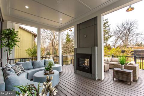 sunroom / solarium featuring a multi sided fireplace