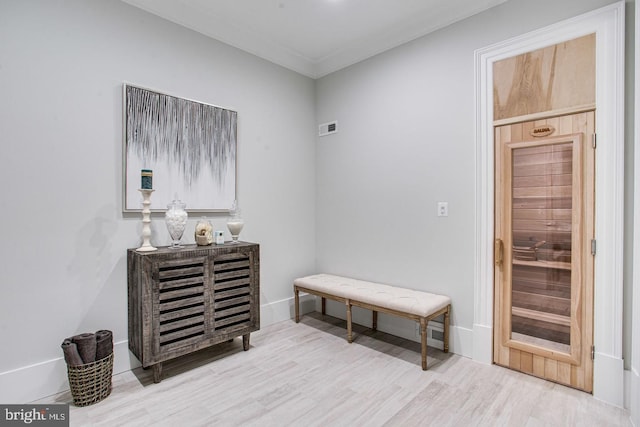 interior space featuring light hardwood / wood-style flooring and crown molding