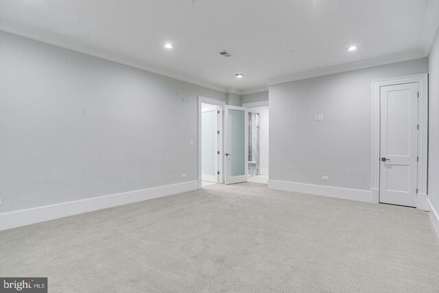 unfurnished room with light colored carpet and crown molding