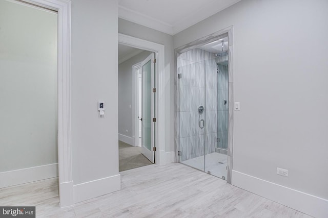 bathroom with walk in shower and crown molding