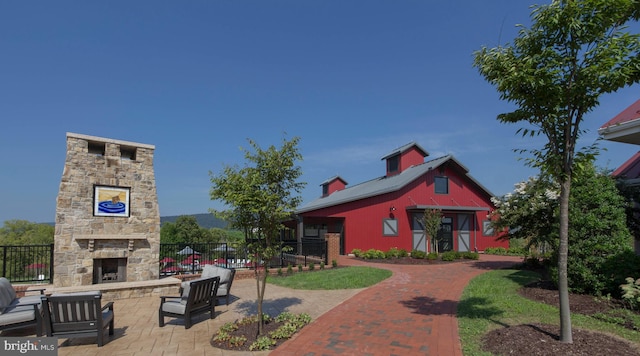 view of front facade with an outdoor stone fireplace