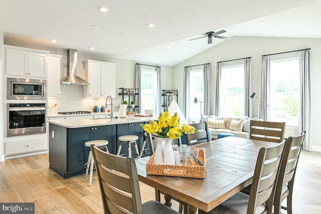 dining area with light hardwood / wood-style flooring, a healthy amount of sunlight, and ceiling fan