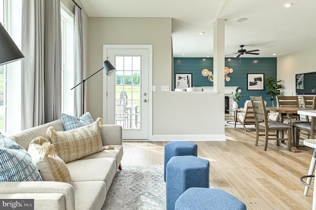 living room featuring ceiling fan and light wood-type flooring