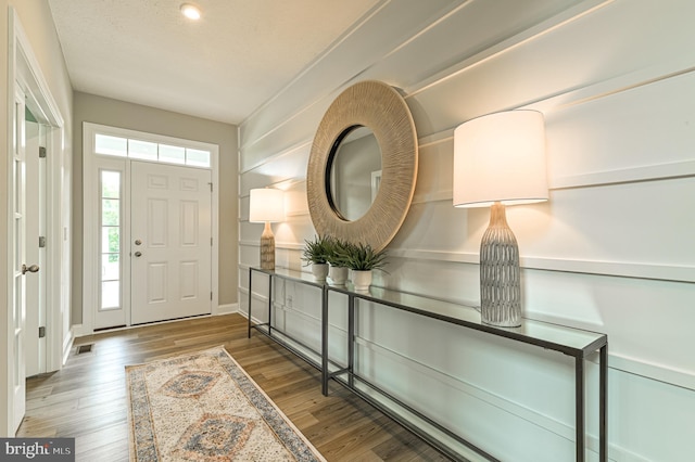 entryway with dark hardwood / wood-style floors