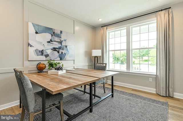 home office with light hardwood / wood-style floors