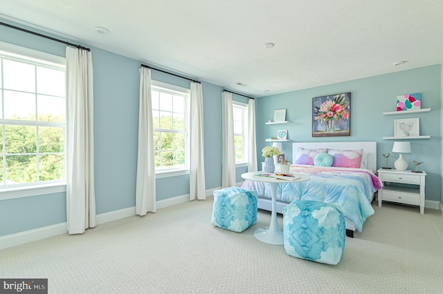 bedroom featuring light colored carpet