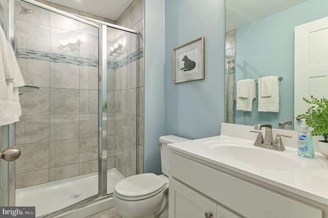 bathroom with a shower with shower door, toilet, and oversized vanity