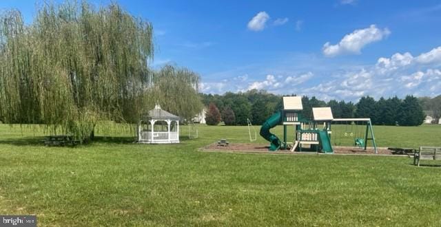 view of playground with a gazebo and a yard