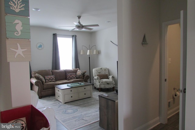 living room featuring light hardwood / wood-style flooring and ceiling fan