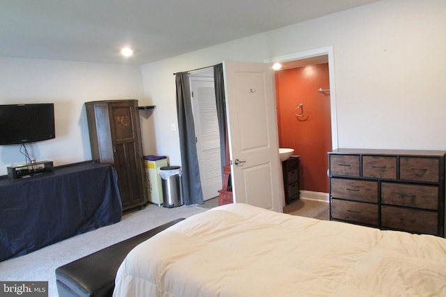 carpeted bedroom featuring connected bathroom