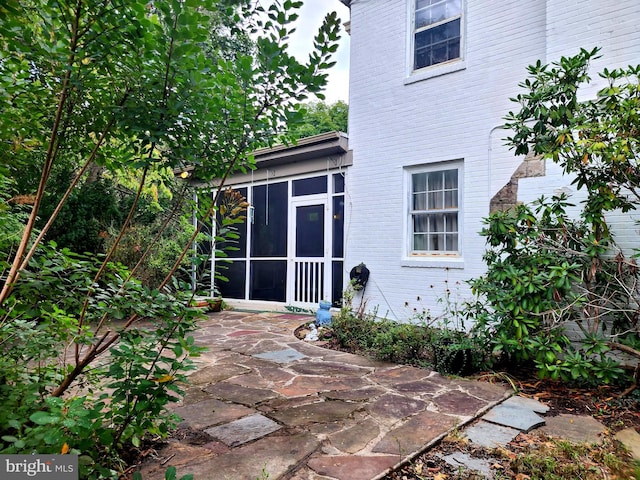 back of house featuring a sunroom and a patio area