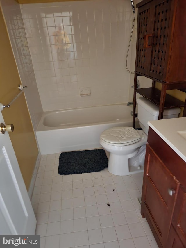 full bathroom featuring tiled shower / bath combo, toilet, tile floors, and vanity