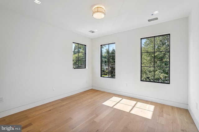 unfurnished room with light wood-type flooring