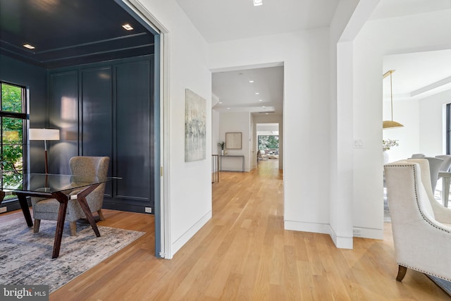 corridor with light hardwood / wood-style flooring