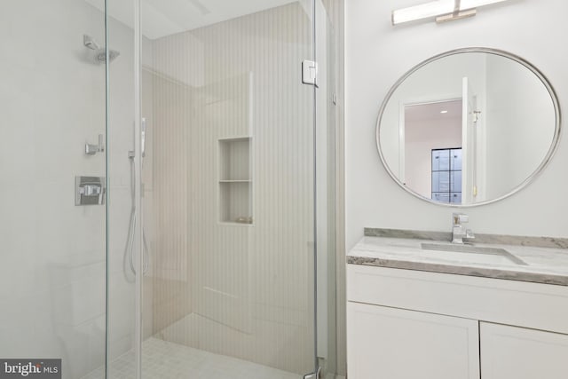 bathroom featuring vanity and an enclosed shower